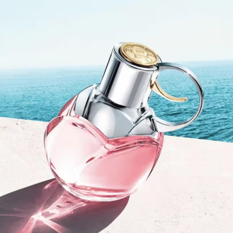 Azzaro Wanted Girl Tonic pink perfume bottle lifestyle image