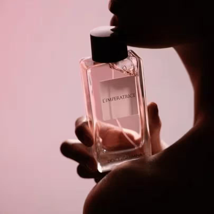 Hand holding Dolce & Gabbana L'Imperatrice Eau de Toilette bottle.
